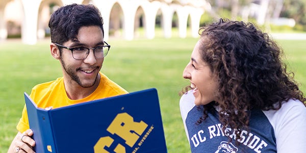 UCR Peer Mentor talks with student.